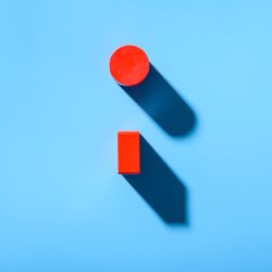 long shadow cast by two red blocks on a light blue 2026 01 05 06 31 utc